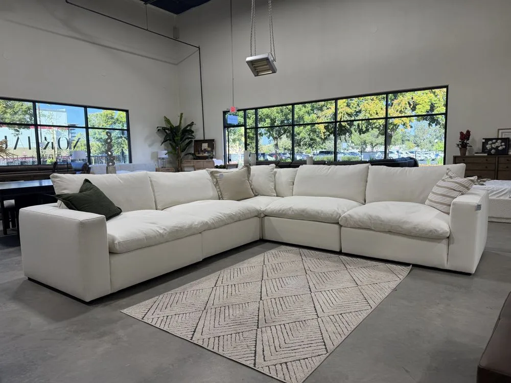 A generously sized white sectional sofa displayed in the bright Norhaus Furniture showroom